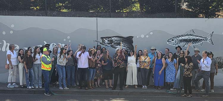 Many of the artists who created the mural were part of the ribbon-cutting ceremony. In all, 67 artists created the work. Photo by Paul Valencia