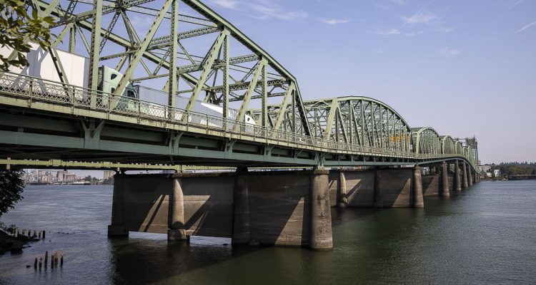 Joe Cortright says the I-5 Bridge replacement is more than two years behind schedule, with the Record of Decision now unlikely before April 2026, raising costs and taxpayer concerns.