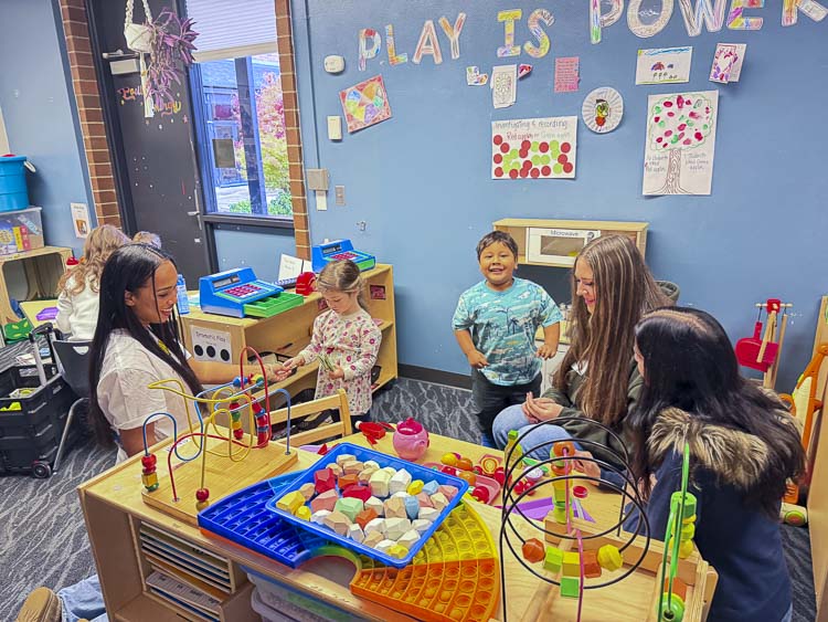 Ridgefield High School students spend time with preschoolers at the Early Learning Center, applying what they’ve learned about child development in real-world settings. Photo courtesy Ridgefield School District