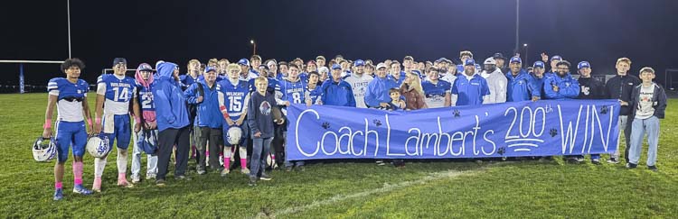 A big moment deserves a big poster. John Lambert and the La Center football family celebrate his 200th win as La Center’s head coach. Photo by Paul Valencia
