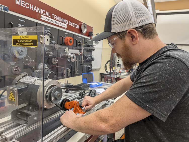 MTX student completes the lab project on a mechanical training system. Photo courtesy Clark College Communications