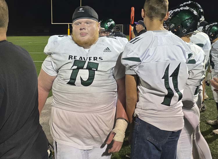 Isaiah Mattison, in the middle of it all, displays his emotions after Woodland defeated Columbia River last week. Photo by Paul Valencia