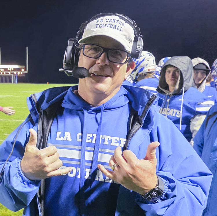 John Lambert shows off his hat to the camera, the same hat he wore for his first win as La Center’s football coach in 1999. He wore it Friday night for win No. 200. Photo by Paul Valencia