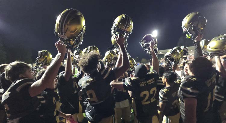 Evergreen football players celebrate their victory over Prairie on Friday at McKenzie Stadium. Photo by Paul Valencia