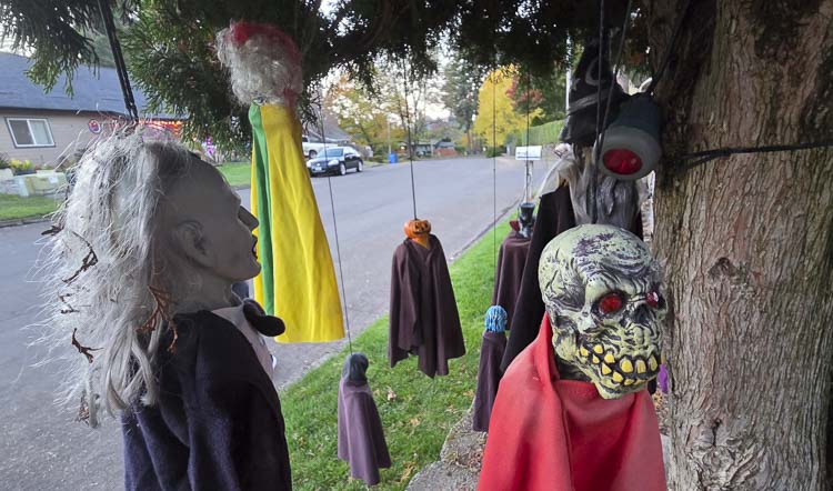 A number of smaller ghosts and goblins and things hang by trees outside the Silver Star Cemetery. Photo by Paul Valencia