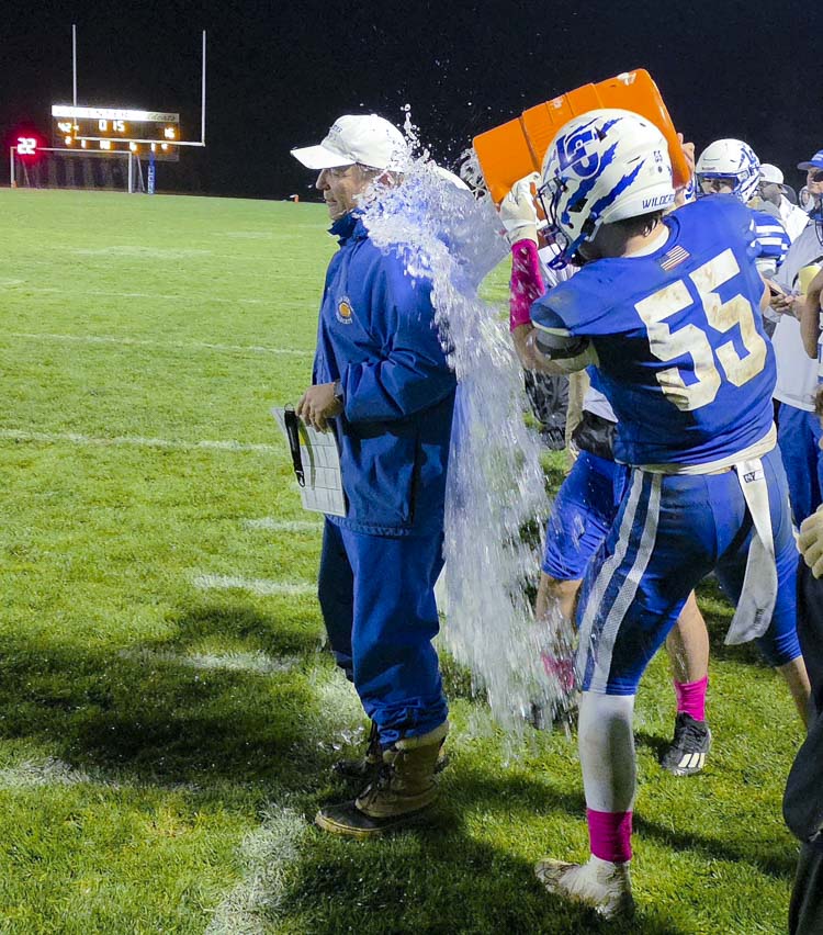 La Center senior Mason Klein (55) dumps water on coach John Lambert in celebration of La Center’s win over Kalama on Friday. It was Lambert’s 200th win as the school’s head coach. Photo by Paul Valencia