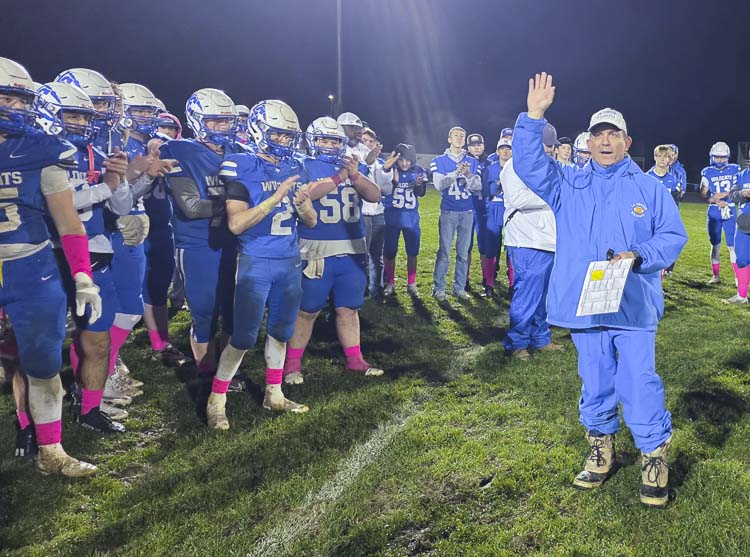 La Center coach John Lambert waves to the home crowd and thanks the fans for their support. The fans were waving cards with 200 printed on them. Lambert won his 200th game as a head coach, all with La Center football. Photo by Paul Valencia