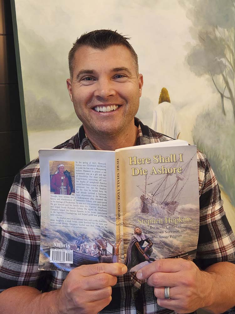 Michael Terry holds up a book detailing the life of his great-times-a-lot grandfather, Stephen Hopkins. Terry said he is a 12th-generation American. Photo courtesy Terry family