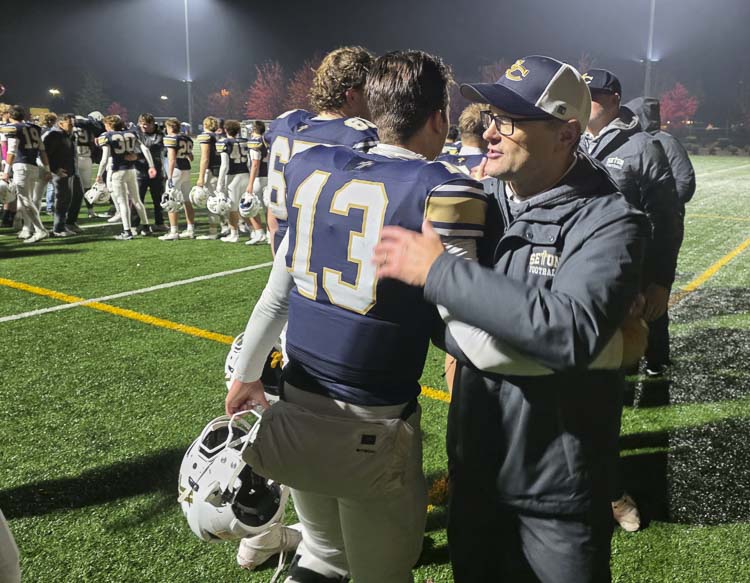 Seton Catholic coach Dan Chase celebrates with his players, including Kolten Gesser. Chase said Gesser has been instrumental not only as a football player but as a leader this season. Photo by Paul ValenciaSeton Catholic coach Dan Chase celebrates with his players, including Kolten Gesser. Chase said Gesser has been instrumental not only as a football player but as a leader this season. Photo by Paul Valencia