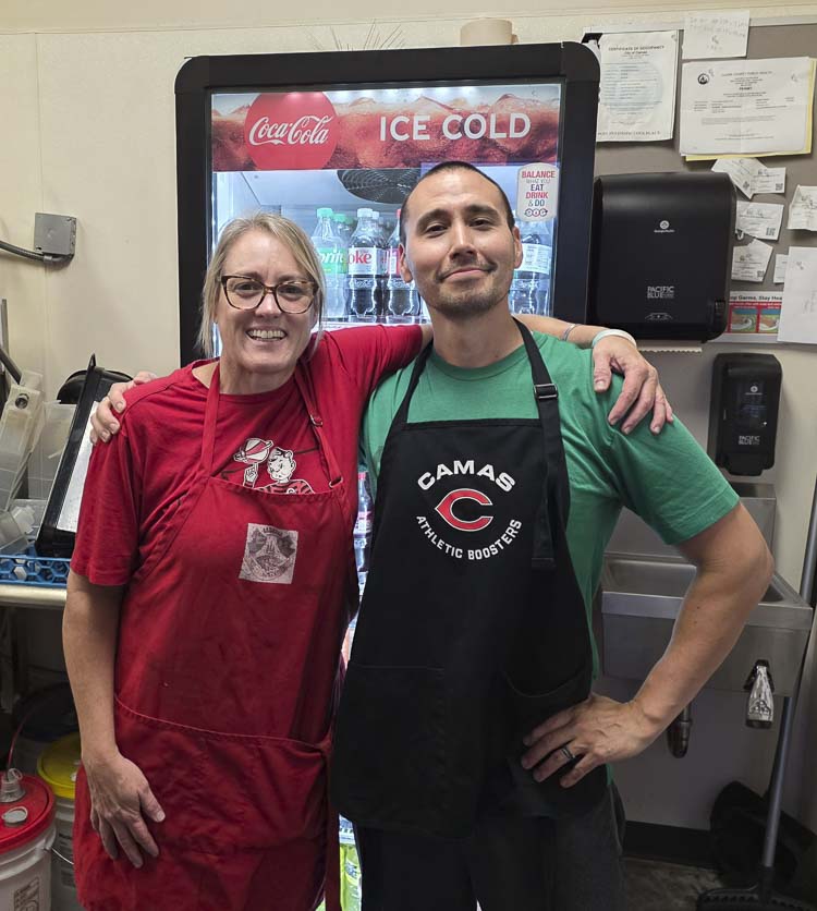 Lisa Schneider is the concessions manager at Doc Harris Stadium and Sean Tamura is the “grillmaster.” Photo by Paul Valencia