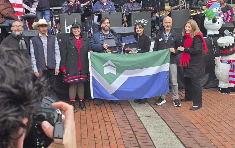 Nathan Hunter and Brooke Nugent hold up keys to the city as they and others show up the new official Vancouver City Flag at Esther Short Park on Friday. Photo by Paul Valencia