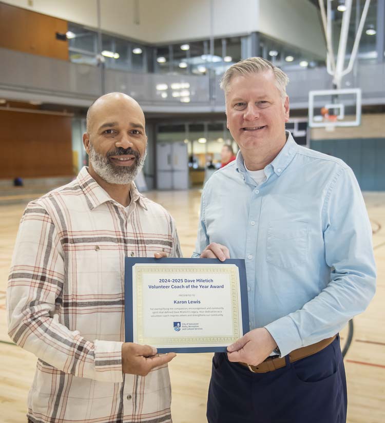 Director David Perlick (on right) and award winner Karon Lewis (on left) are shown here in front of the Dave Miletich Coach of the Year award display at the Firstenburg Center. Photo courtesy city of Vancouver