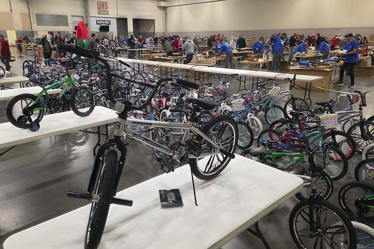 More than 100 volunteers showed up Saturday morning to assemble bicycles at the annual Scott Campbell Christmas Promise Bike Build. Photo by Paul Valencia