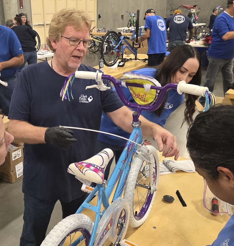 Terry Toland, a bicycling enthusiast himself, loves assembling bicycles for others, as well. He appreciates the annual Bike Build, allowing volunteers to help give the gift of a bicycle to children in Clark County. Photo by Paul Valencia