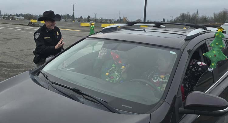 Clark County Sheriff John Horch greets some of the volunteers who make Santa’s Posse possible. Photo by Paul Valencia