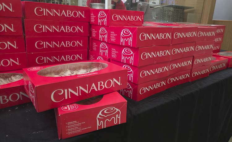 There was a long line of people at Cinnabon on Tuesday, with many looking to grab one of the red boxes full of deliciousness. Photo by Paul Valencia
