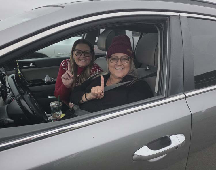 Driver Amy Mullins and friend Soozie Caldera were the first in line for Santa’s Posse on Saturday. They arrived at 5:55 a.m., almost two hours before pick-up started for special deliveries throughout Clark County. Photo by Paul Valencia