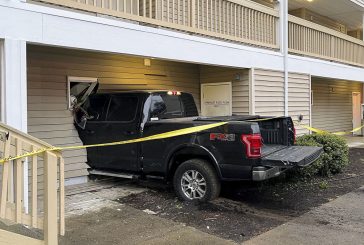 Truck crashes into apartment complex