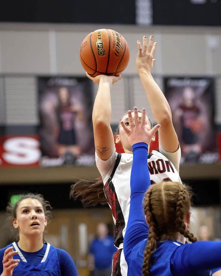Brooklynn Haywood of Union gets a shot off with a hand in her face Saturday in a Class 4A state girls basketball tournament game at Camas High School. Union won to advance to the state quarterfinals. Photo courtesy Heather Tianen