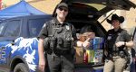 Nearly 8,500 snacks filled police cruisers at Fred Meyer as the community rallied to stock high school pantries and build new relationships.