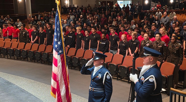 Military recruits stand in the background Wednesday night as the nation’s colors are posted at the Our Community Salutes event at Skyview High School. Dozens of recruits for the Army, Marines, Navy, Air Force, and Coast Guard took their ceremonial oaths of enlistment. Photo by Paul Valencia