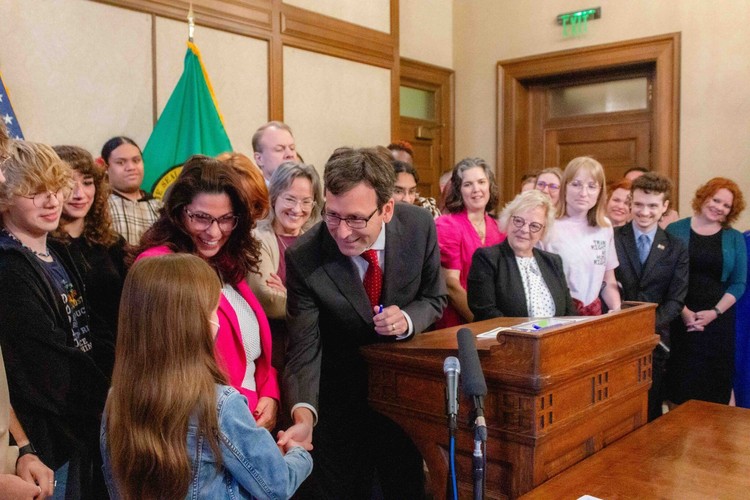  Gov. Bob Ferguson hands over one of the pens he used to sign House Bill 1296, the ‘students bill of rights’ to a child who attended the bill signing.