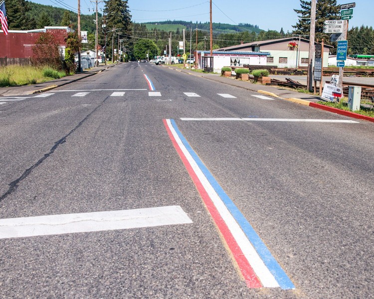 Red, white and blue centerline road striping covers the top of the yellow striping on Yacolt Road on Friday, May 22. However, a complaint to the town may result in the centerline striping being painted over with standard yellow. Red, white and blue centerline road striping covers the top of the yellow striping on Yacolt Road on Friday, May 22. However, a complaint to the town may result in the centerline striping being painted over with standard yellow.