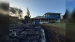 Four engines and two truck companies held a three-outbuilding blaze to the structures, sparing an adjacent home.