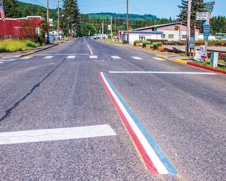 Red, white and blue centerline road striping covers the top of the yellow striping on Yacolt Road on Friday, May 22. However, a complaint to the town may result in the centerline striping being painted over with standard yellow.