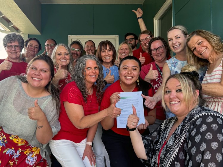 Members of the Evergreen Education Association and Evergreen Public Schools negotiating teams celebrate their agreement on a new five-year collective bargaining agreement.