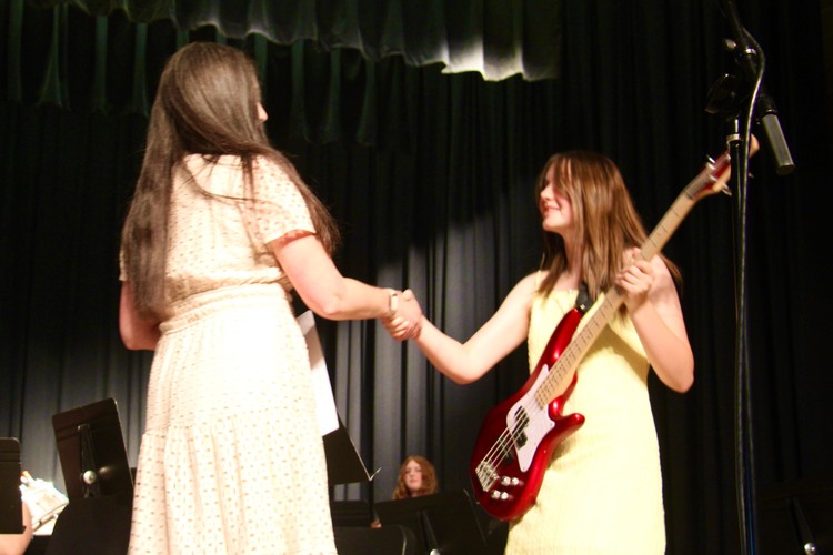 Eighth grader Piper Henry-Zimmermann accepts the Outstanding Musician Award from Director of Bands Alison Pierce.