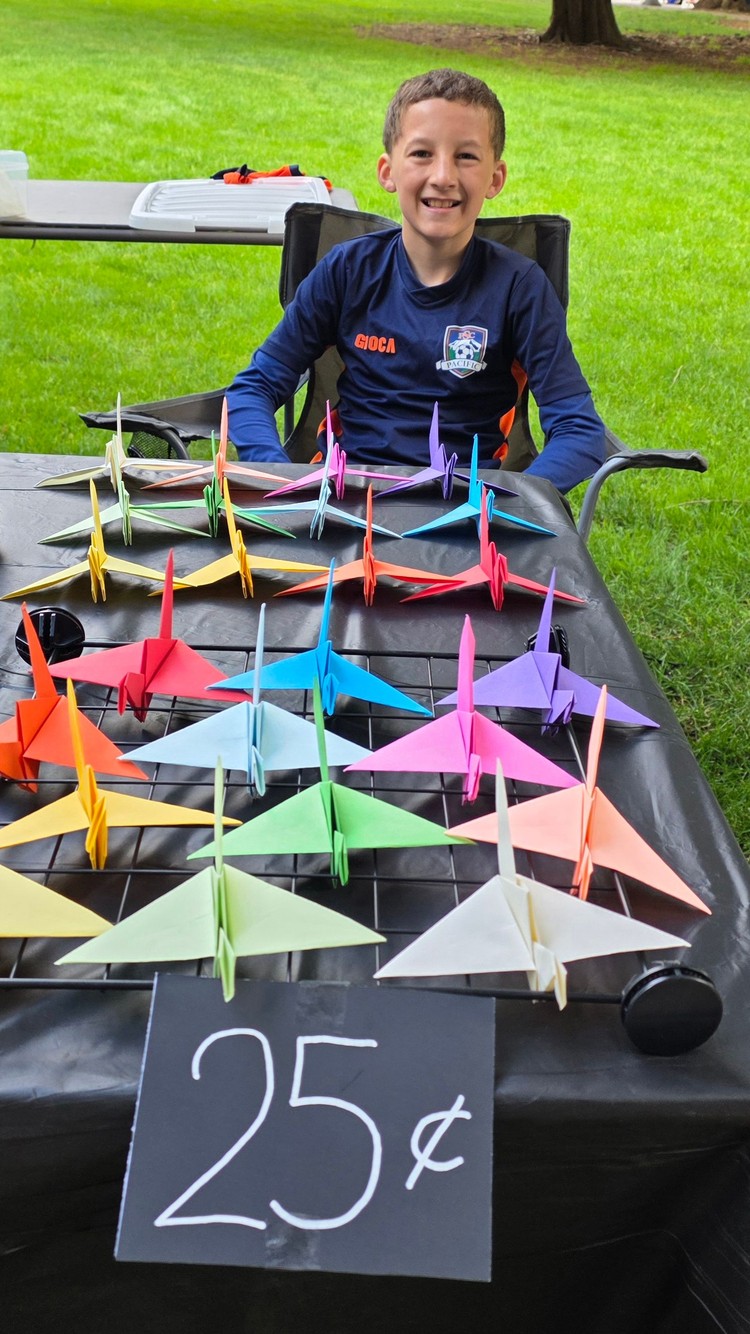 Noah Dominga makes flapping wings using Origami, and he sells them at the Greater Vancouver Chamber Lemonade Day Junior Market.
