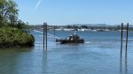 16 firefighters — including marine units — battled a lumber pile fire on a remote Columbia River peninsula.