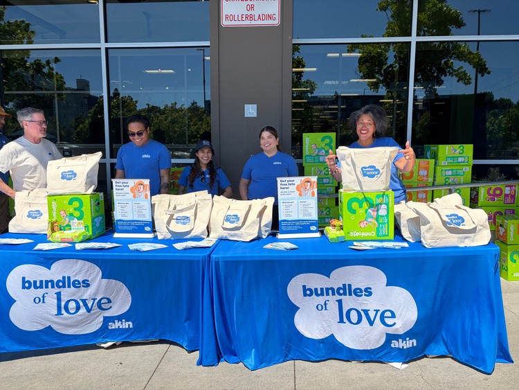 Akin COO Dr. Daniele Lyman-Torres (far right) assisting staff with giveaway.
