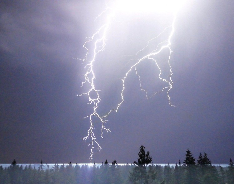 A lightning strike branches down from the sky hitting an area west of Battle Ground on Thursday, July 16.