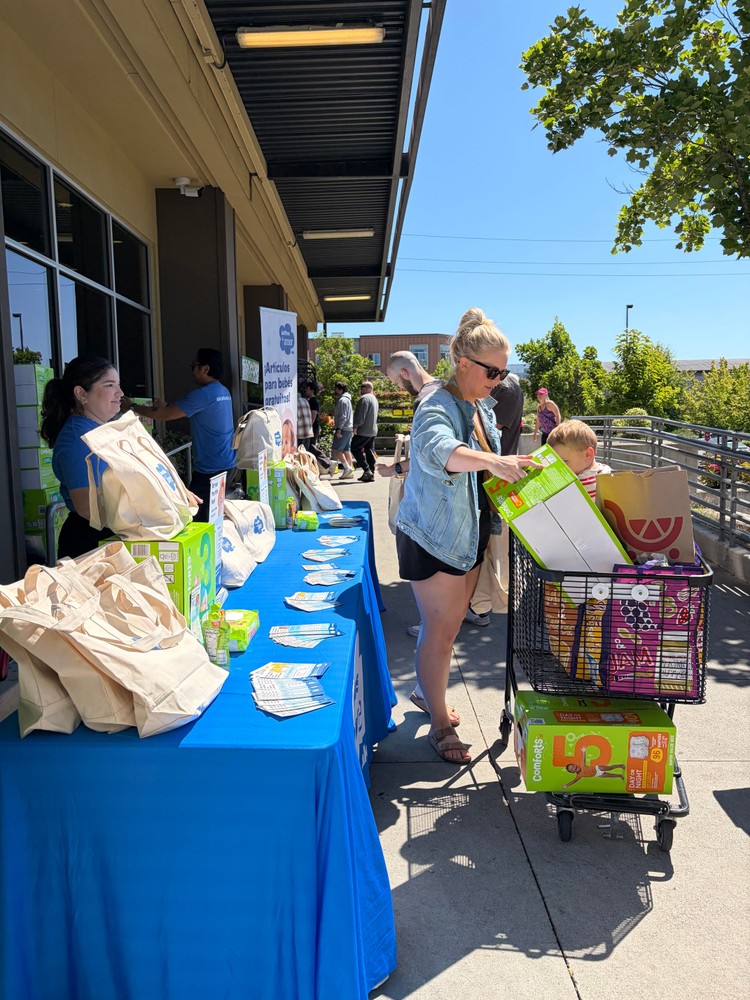 Families collecting giveaway materials.