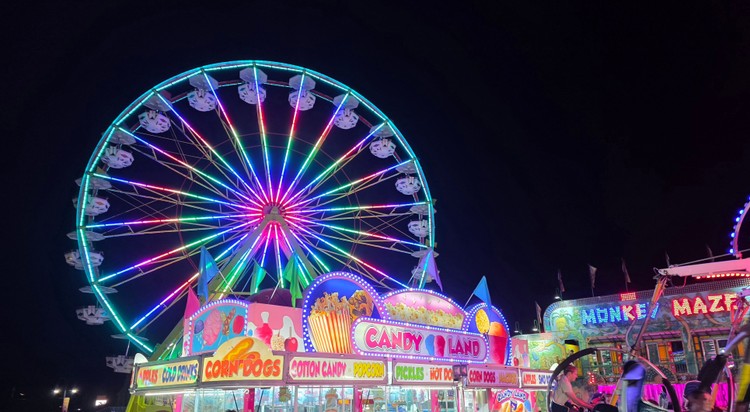 Paul Valencia captures the Clark County Fair's nighttime energy, where carnival rides blaze with color until 11 p.m. on Fridays and Saturdays.