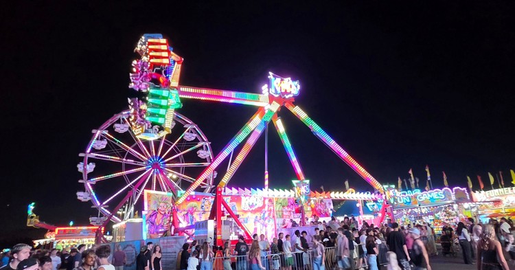 Paul Valencia captures the Clark County Fair's nighttime energy, where carnival rides blaze with color until 11 p.m. on Fridays and Saturdays.