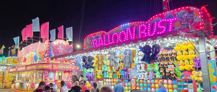 Paul Valencia captures the Clark County Fair's nighttime energy, where carnival rides blaze with color until 11 p.m. on Fridays and Saturdays.