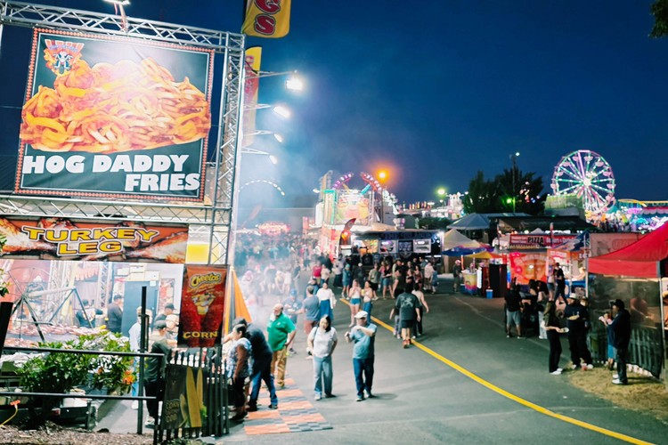 Paul Valencia captures the Clark County Fair's nighttime energy, where carnival rides blaze with color until 11 p.m. on Fridays and Saturdays.