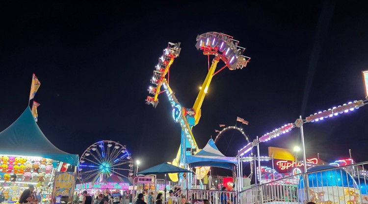Paul Valencia captures the Clark County Fair's nighttime energy, where carnival rides blaze with color until 11 p.m. on Fridays and Saturdays.