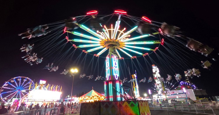 Paul Valencia captures the Clark County Fair's nighttime energy, where carnival rides blaze with color until 11 p.m. on Fridays and Saturdays.