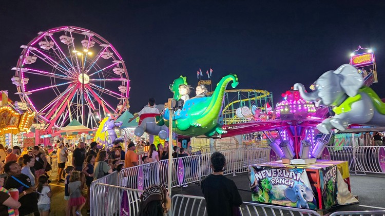 Paul Valencia captures the Clark County Fair's nighttime energy, where carnival rides blaze with color until 11 p.m. on Fridays and Saturdays.